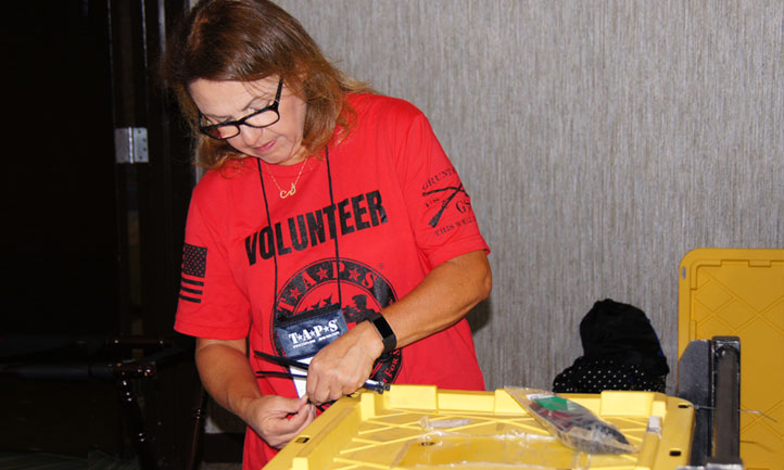 volunteer in Denver packs supplies at the Colorado Regional Seminar and Good Grief Camp