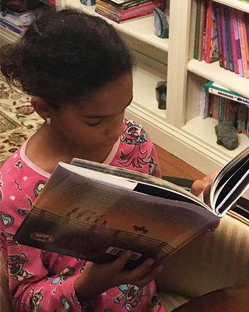 Arianna Bryant reading “Klinger: A Story of Honor and Hope” is one of her favorite books.