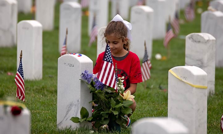 Young Survivor at headstone in Arlington National cemetery