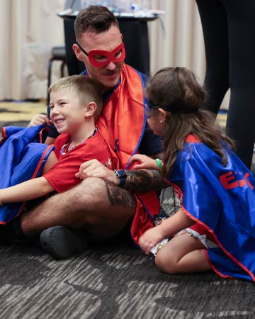 Mentor and Children in Superhero costumes