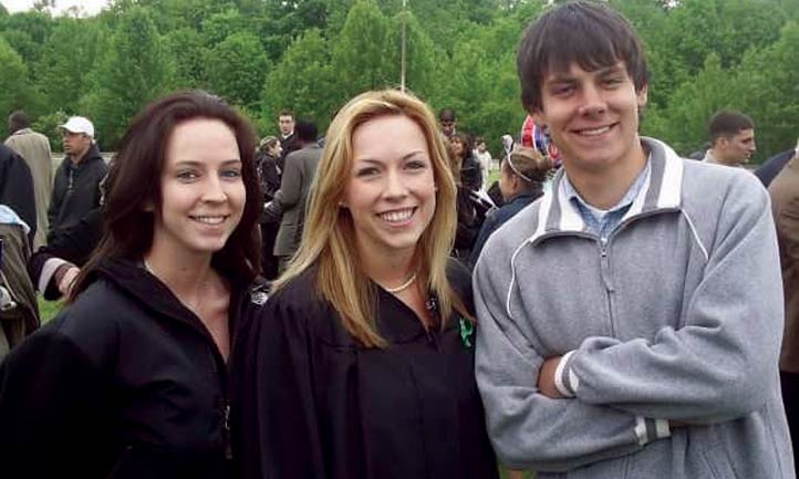 Owen and sisters at graduation