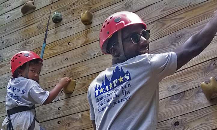 Survivors climbing rock wall