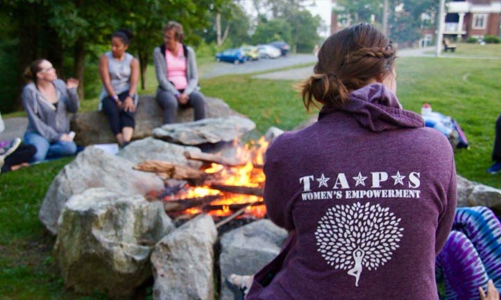 Surviving Women gather around fire pit