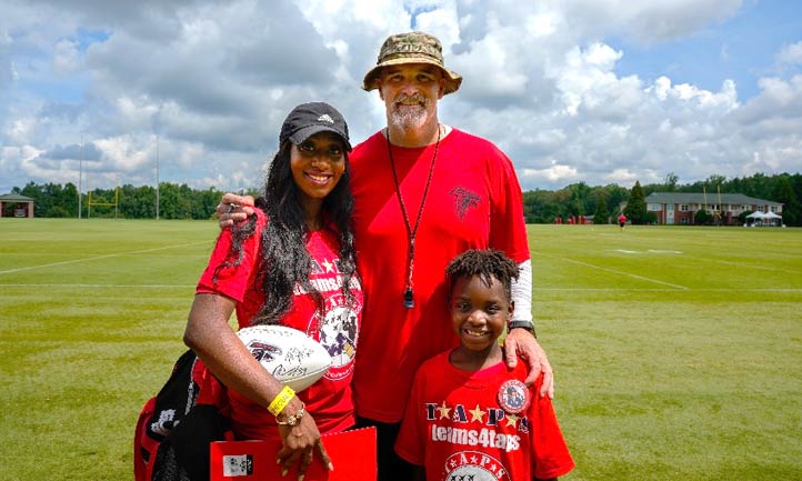 TAPS mom and son with Falcons head coach Dan Quinn