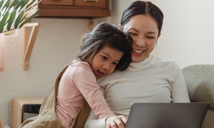 mom and child looking at computer