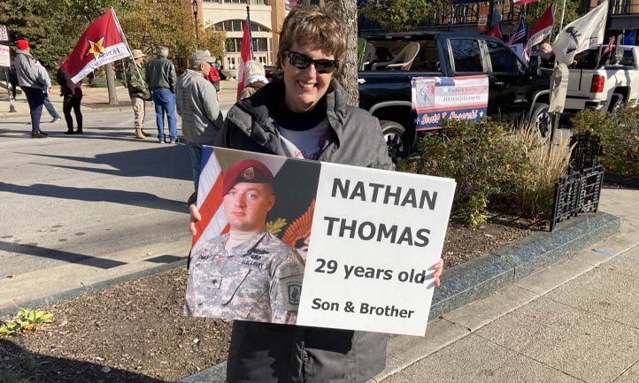 Judy Thomas with photo of son at Veteran's Day Parade