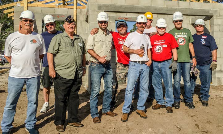 Surviving Men at TAPS Retreat with building project