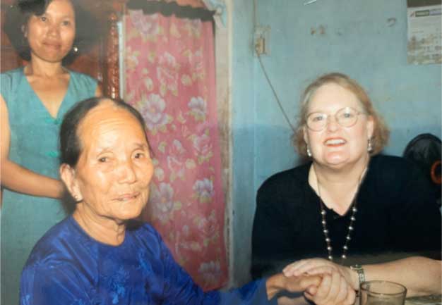 My mom, Sally, with a Vietnamese widow and her daughter in her home