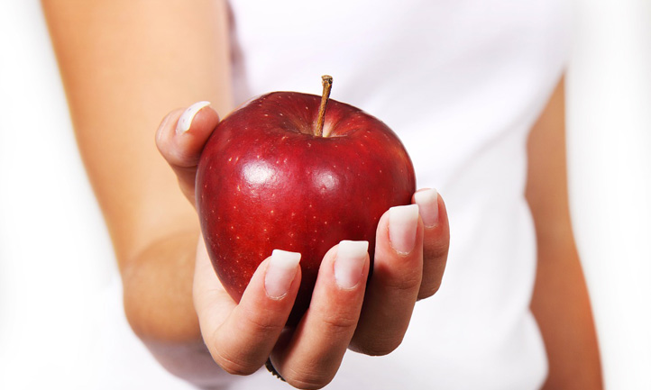 woman holding red apple