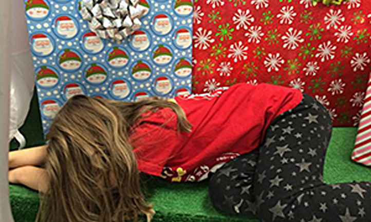 TAPS child asleep by christmas presents