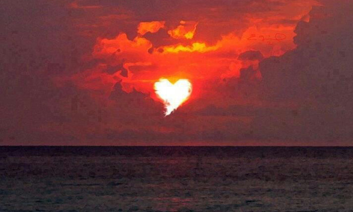 clouds break to form a heart in the sky