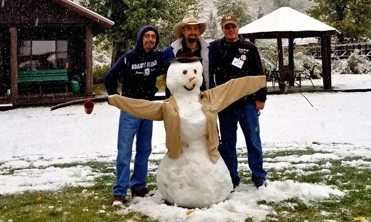 Surviving men building a snowman