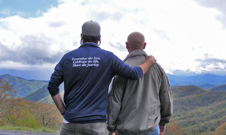 Men Survivors looking out over a lake