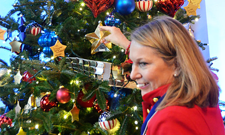 Bonnie Carroll hanging ornament on Christmas Tree