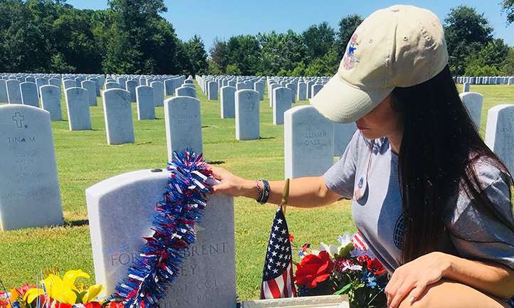 Woman sits at boyfriend's headstone