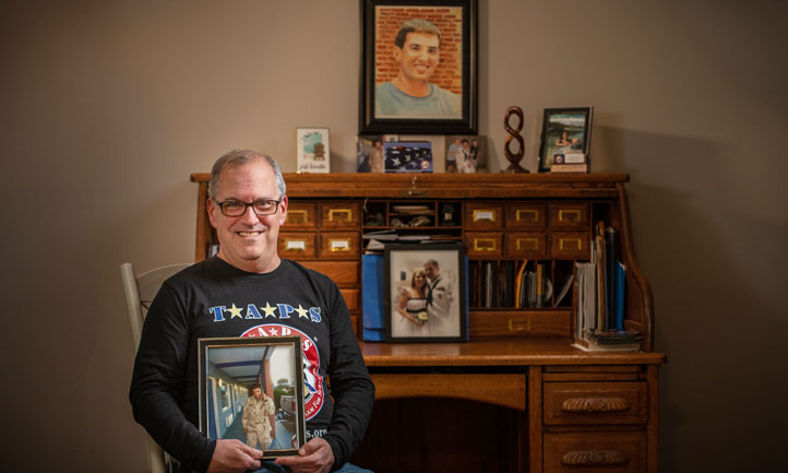 Peer Mentor and Suicide Survivor Don Lipstein with portrait of son Josh