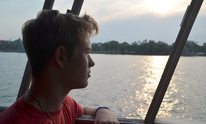 Teen Boy on boat looking out toward shore at National Seminar 2016