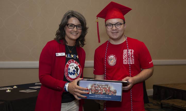 Surviving military teen receives a college care package during TAPS Graduation at the National Military Survivor Seminar in Washington, D.C.