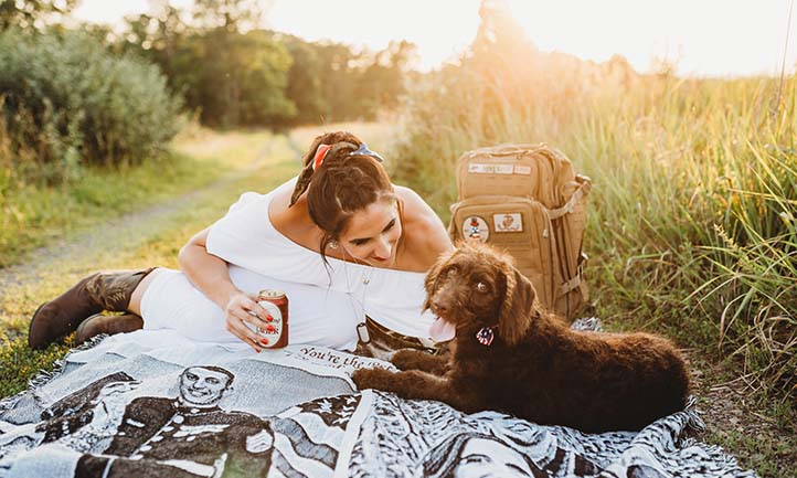 Anna with dog on blanket picturing her fiancé