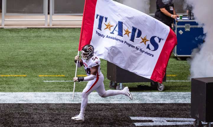 Falcons player carries TAPS flag