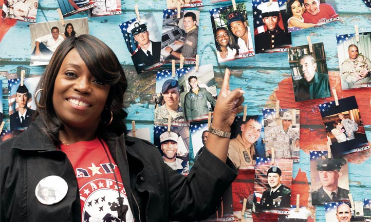 Survivor points to loved one on fallen hero photo wall