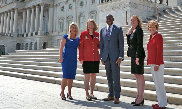 U.S. Capitol background, TAPS Staff and Senator Warnock
