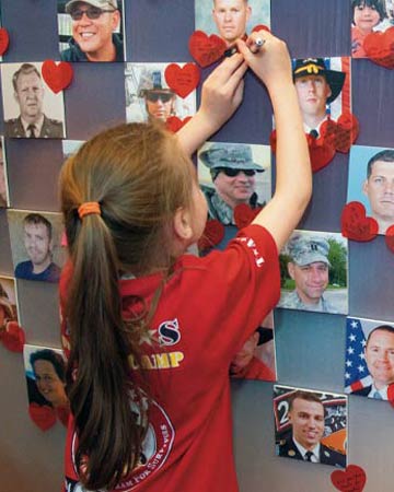 surviving daughter writing message to dad on the hero wall