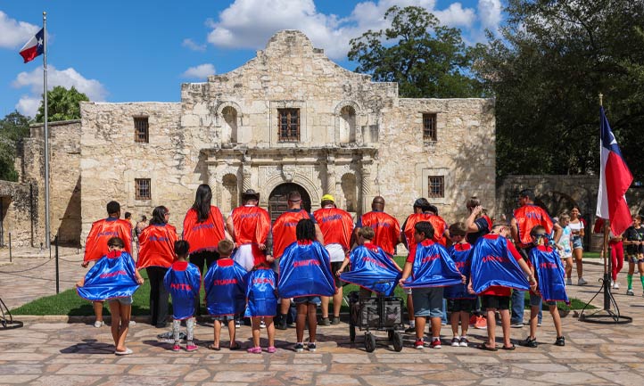 Mentors and Children in Superhero costumes at the Alamo