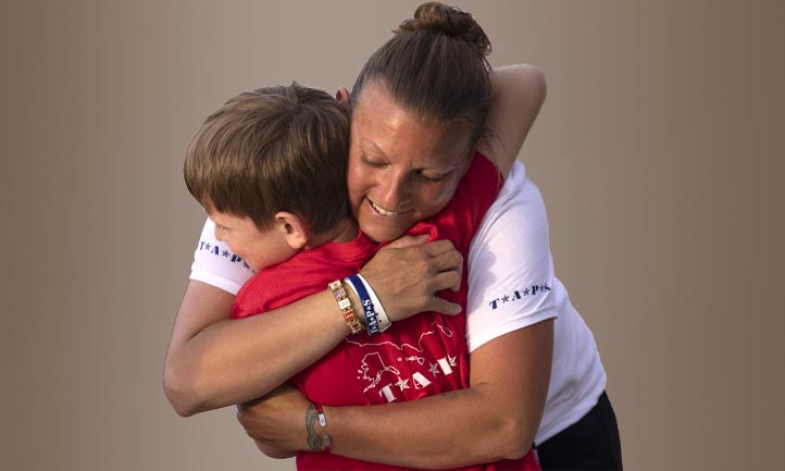 Good Grief Camp Group Leader hugs TAPS Child