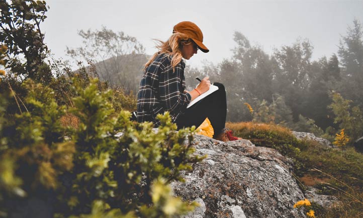 woman outside in nature writing