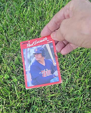 Picking up Baseball card in lawn