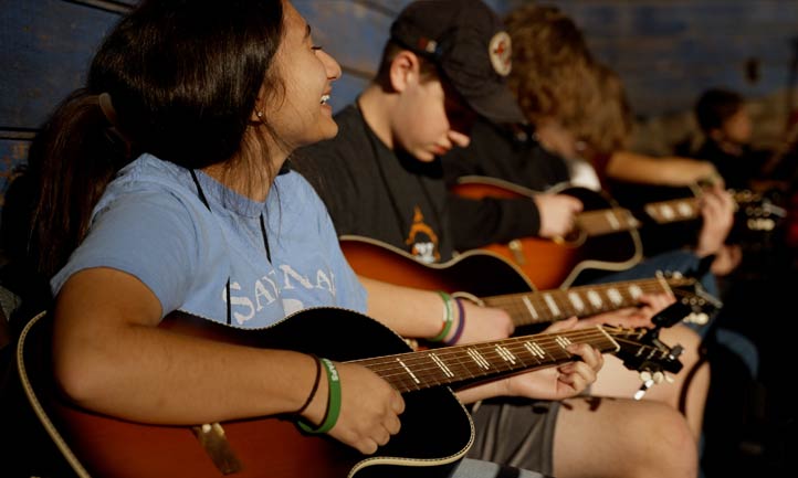 Young Survivors playing guitar