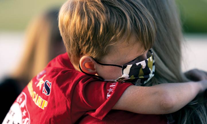 Child hugged by Military Mentor