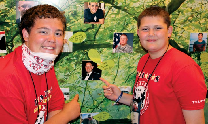 Survivors touching photo of loved one at TAPS Seminar