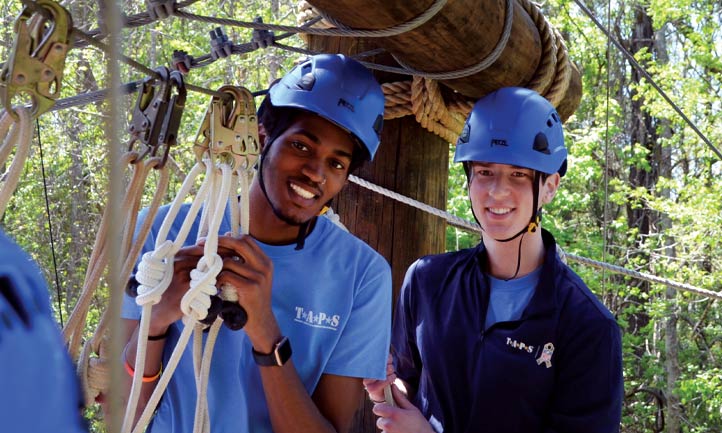 taps young adult attendees on ropes course