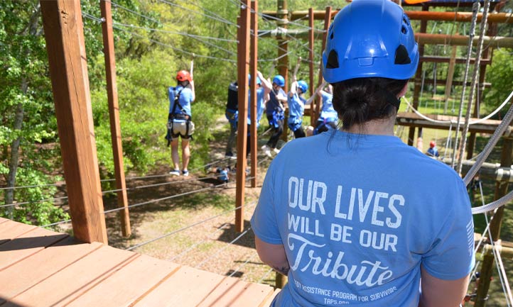 taps young adult attendees on ropes course
