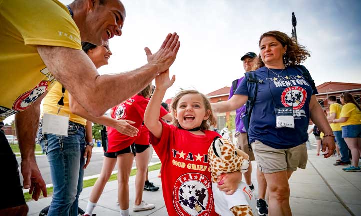 National Seminar - Volunteers High Five Good Grief Camp child