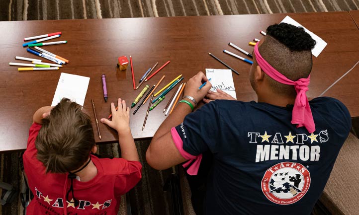 TAPS Military Mentor colors with boy