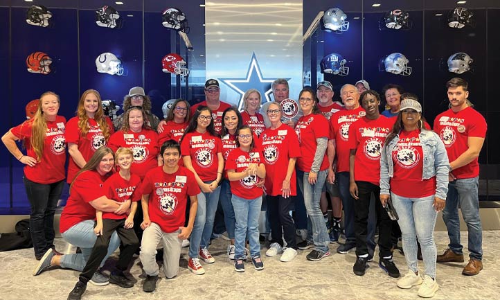 TAPS families huddle up during a visit to the Dallas Cowboys 
