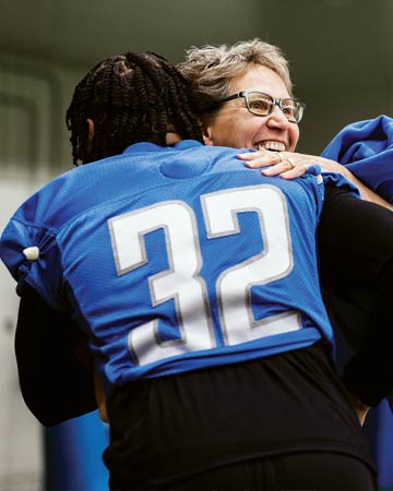 D’Andre Swift of the Detroit Lions hugs Kathleen Johnson