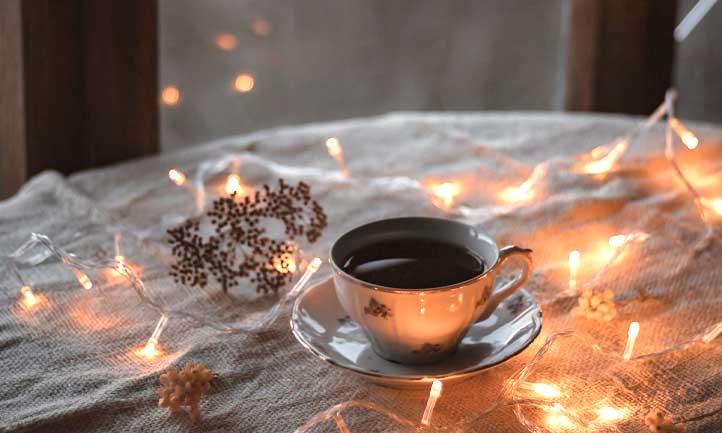 coffee cup and twinkly lights