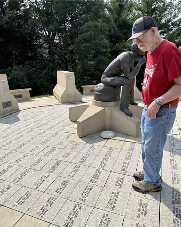 Jim Johnson gazing at son's memorial stone