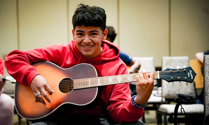 TAPS Teen playing guitar