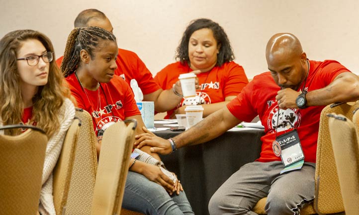 Survivors hold hands at TAPS Seminar