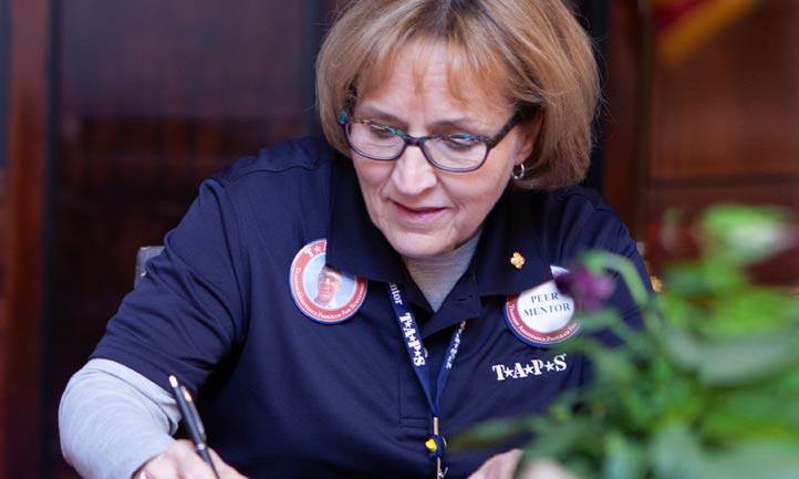 peer mentor writing on paper